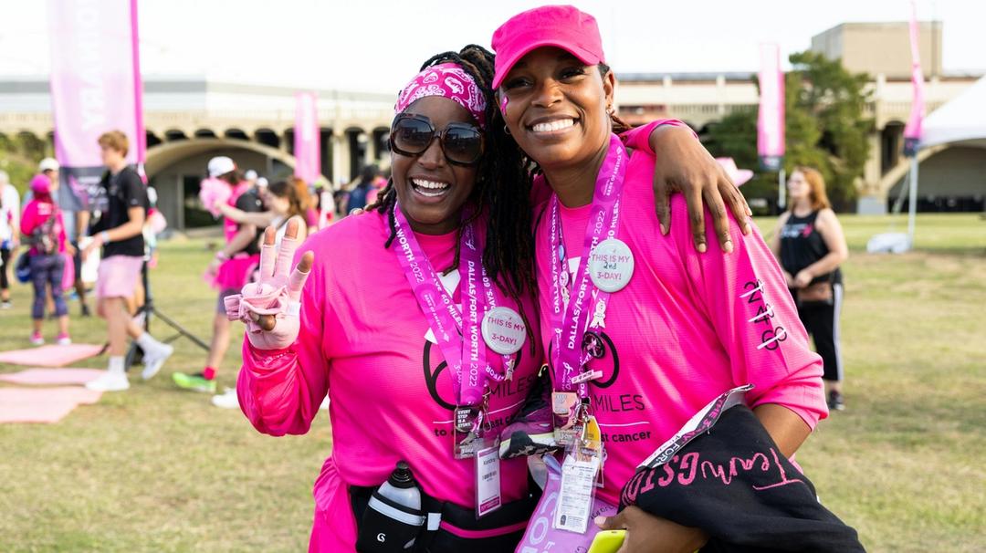 A couple of women in pink at a breast cancer awareness event.