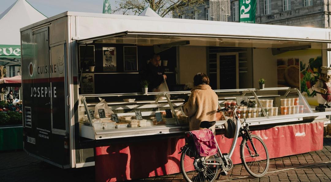 Woman ordering from a concession stand outside.