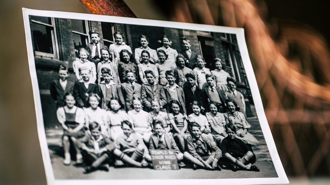 Printed group photograph lying on a table.