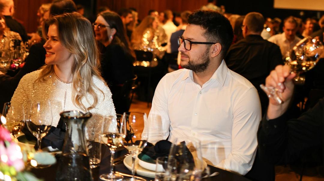 People seated at a formal event.