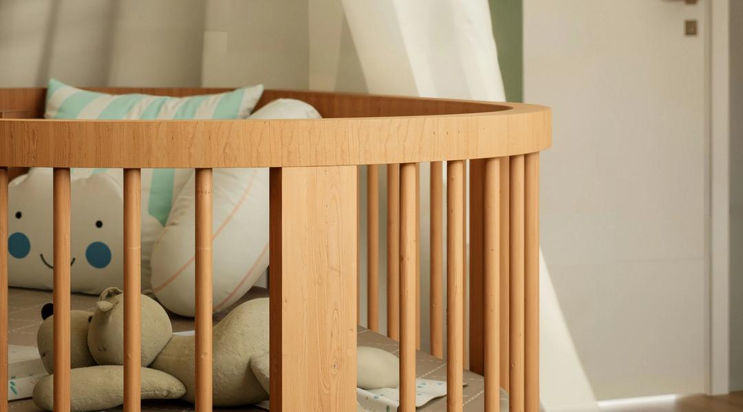 Wooden baby crib with a canopy, pillows, and a stuffed animal.