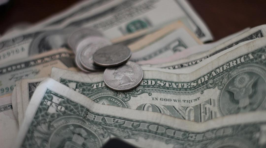 Dollar bills sitting on a table.