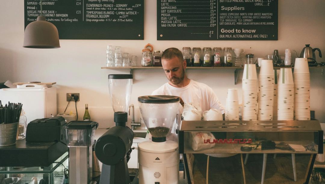Man behind the counter at a small coffee shop.