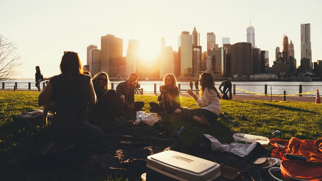 people sitting on a grass field.