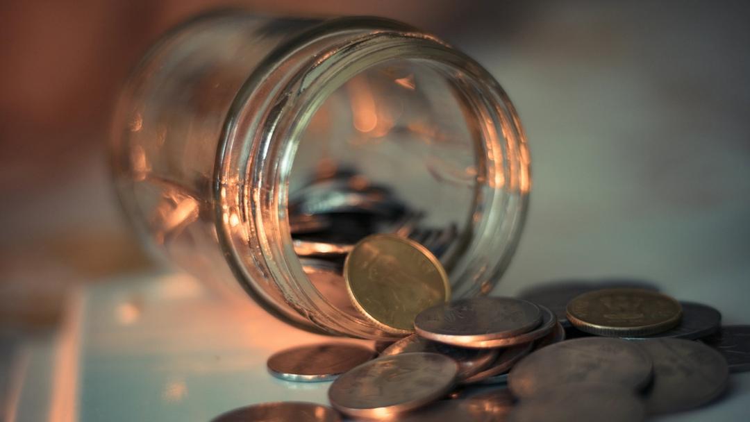 Coins being poured out of a jar.