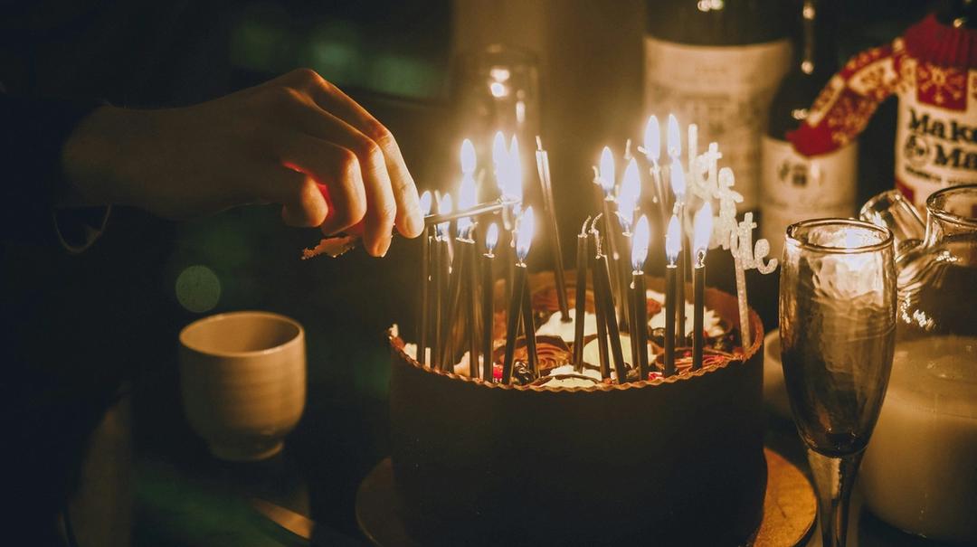 Lighted candles on birthday cake.