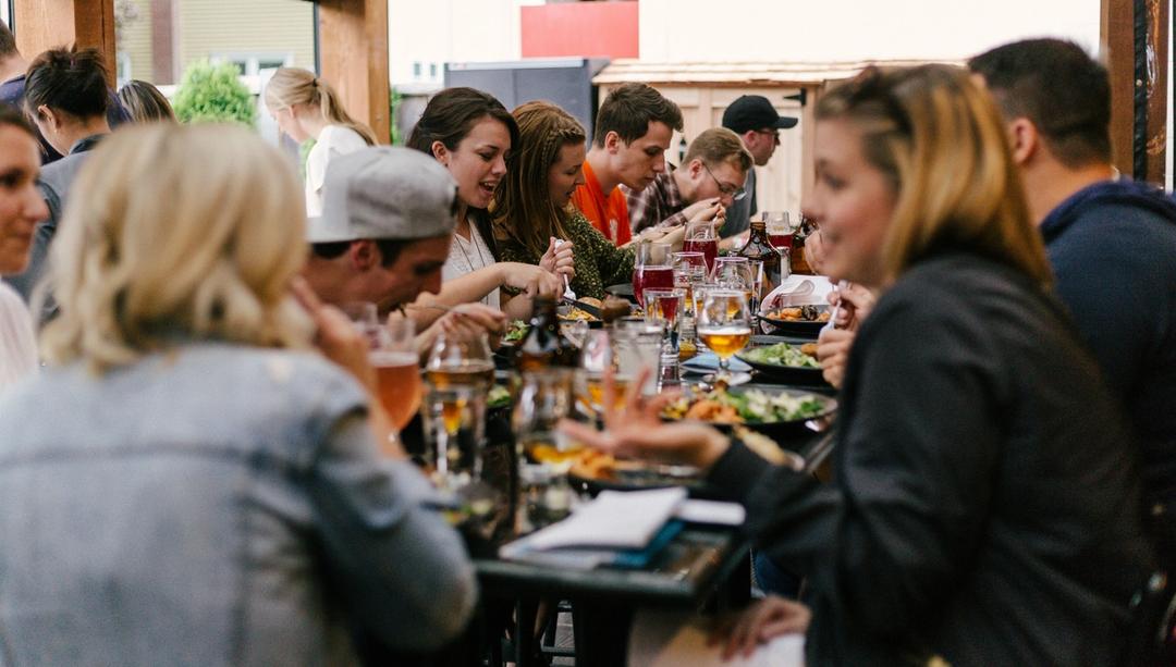 a group of people out to dinner, all sitting at one table.