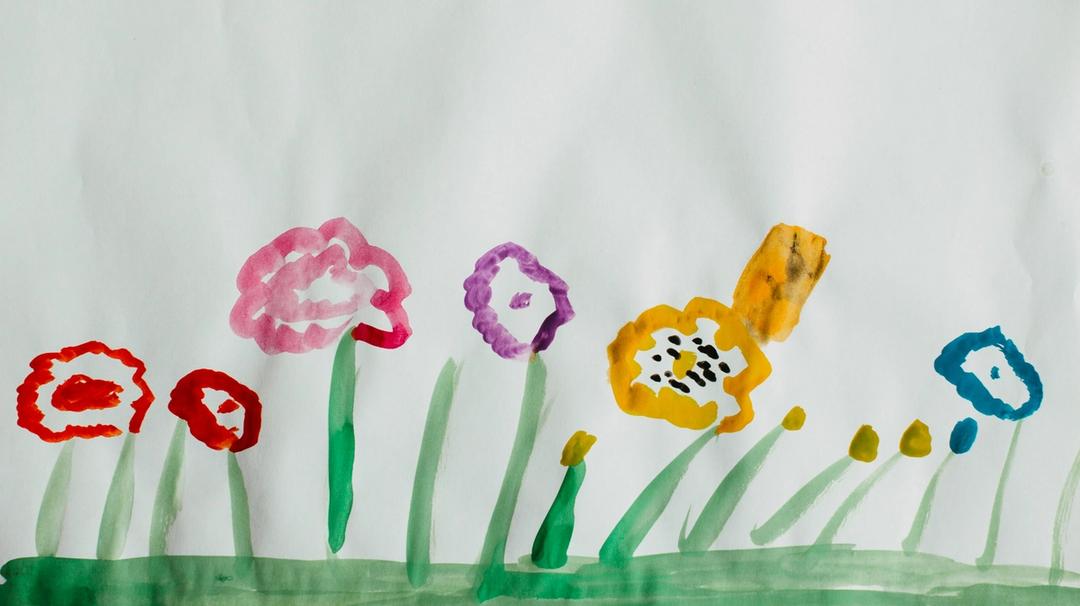 Pink, yellow, and green flower painting by child.
