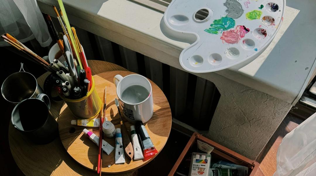 Art supplies sitting on a table.