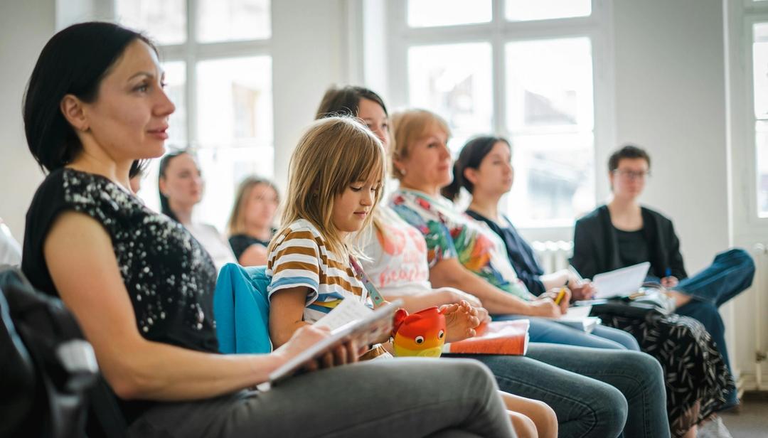 A group of parents and a child in a meeting.