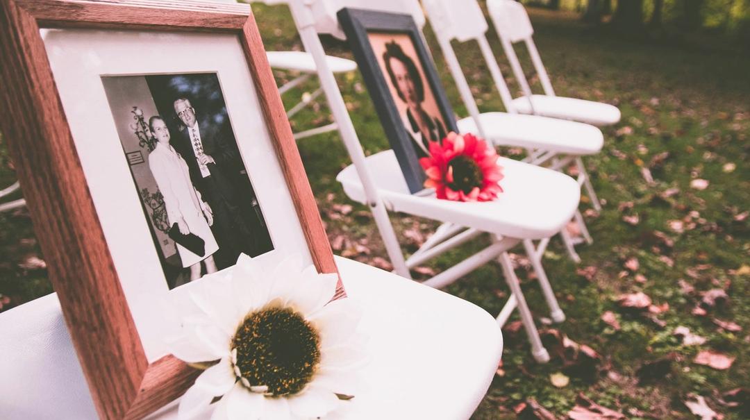 Framed photos of people on seats with flowers on them.