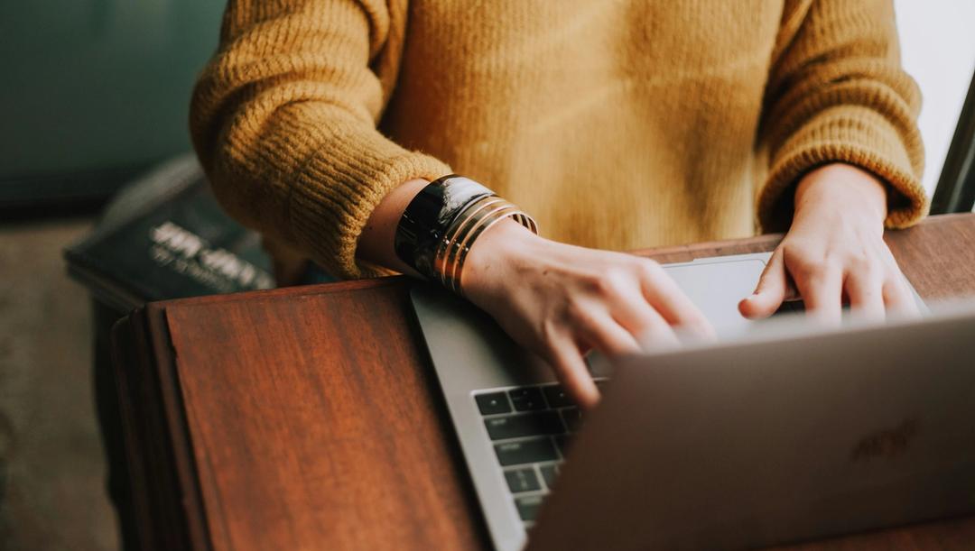 Person typing on a laptop.