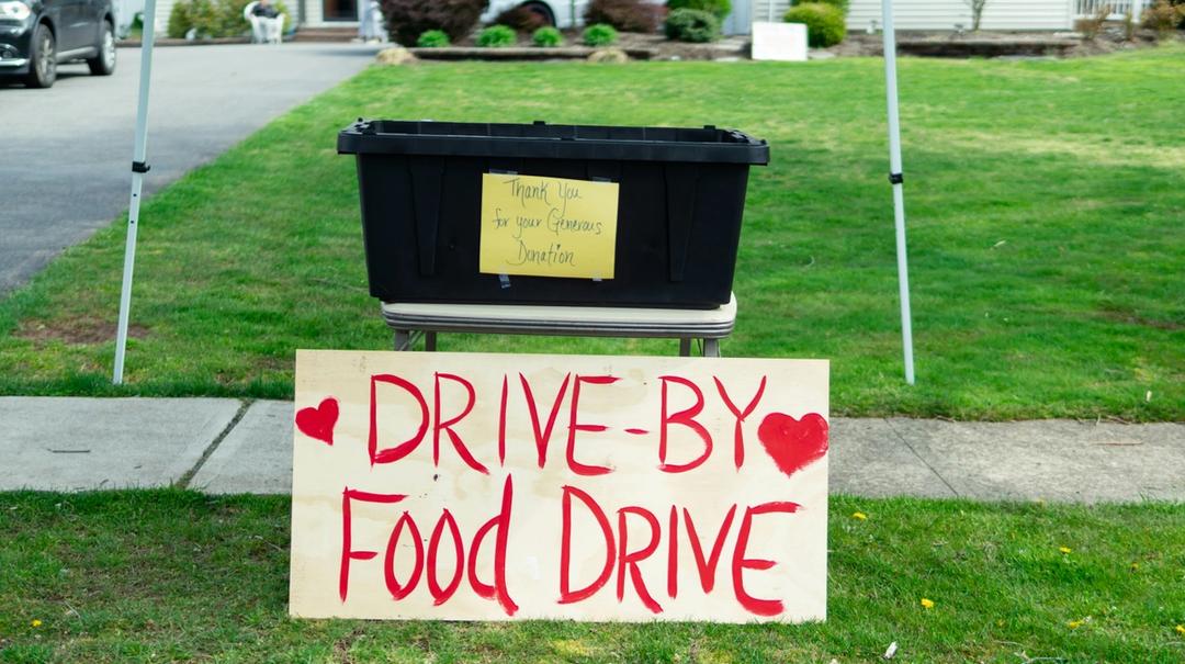 Sign that reads "drive by food drive"