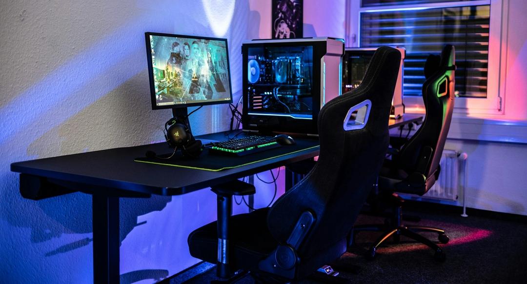 A computer desk with two monitors and a keyboard.