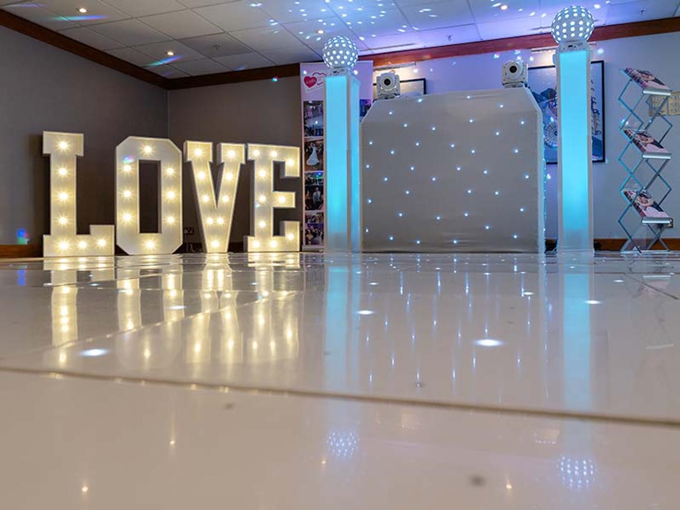 Illuminated LOVE letters beside the dance floor in the Bearsted Room