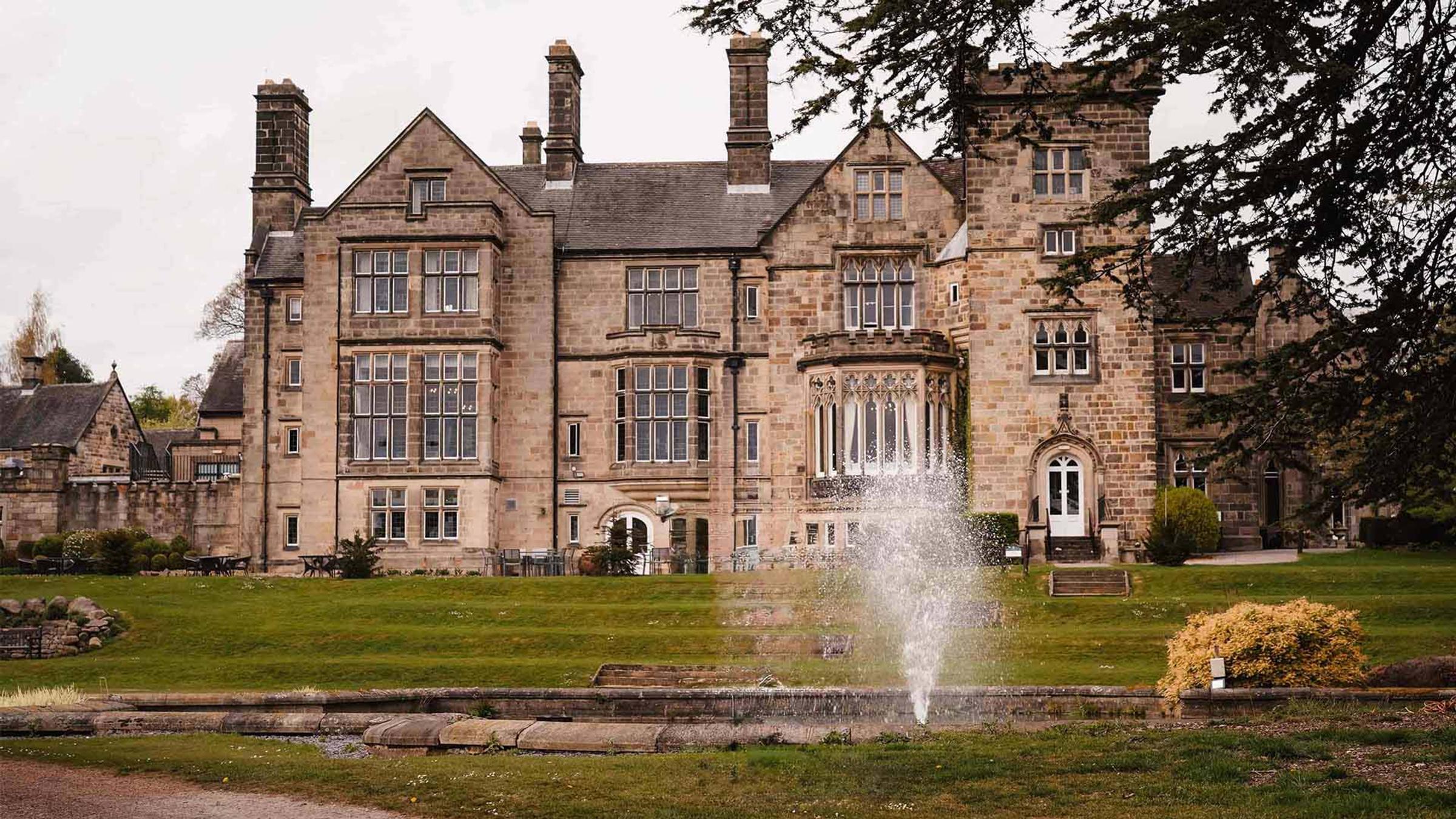 Delta Hotels Breadsall Priory Country Club exterior with fountain and lawn