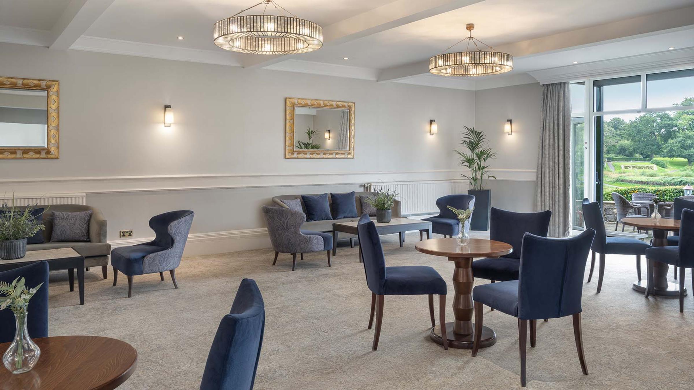 Lounge seating area with chandeliers overlooking the terrace at Delta Hotels St. Pierre Country Club
