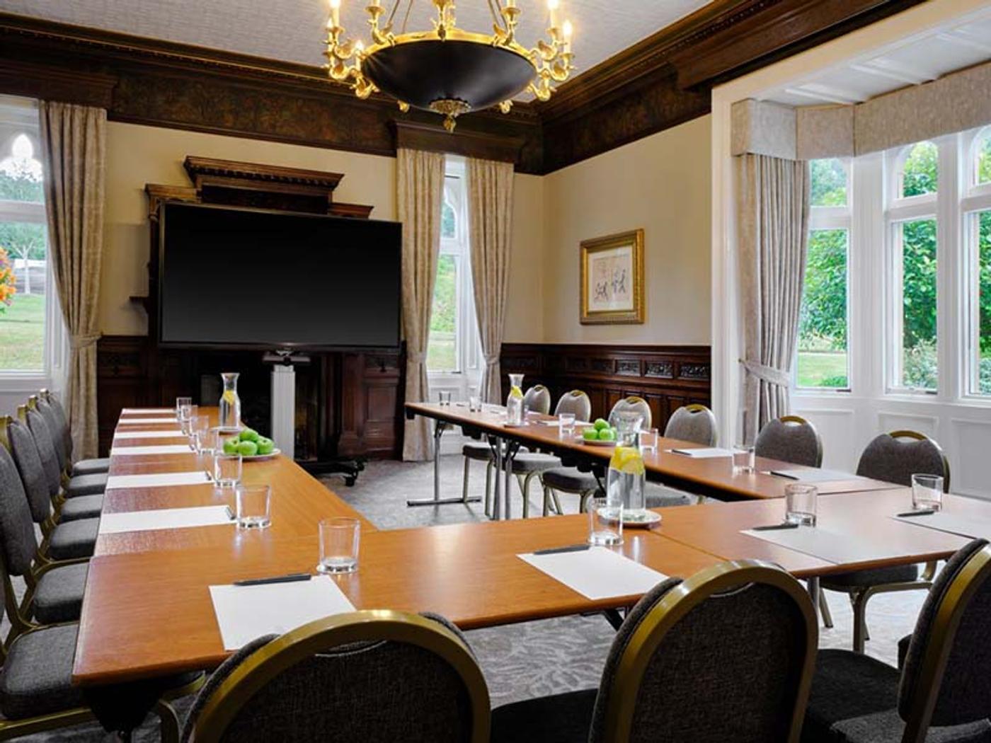 Bay window room set up with round tables for a private dinner