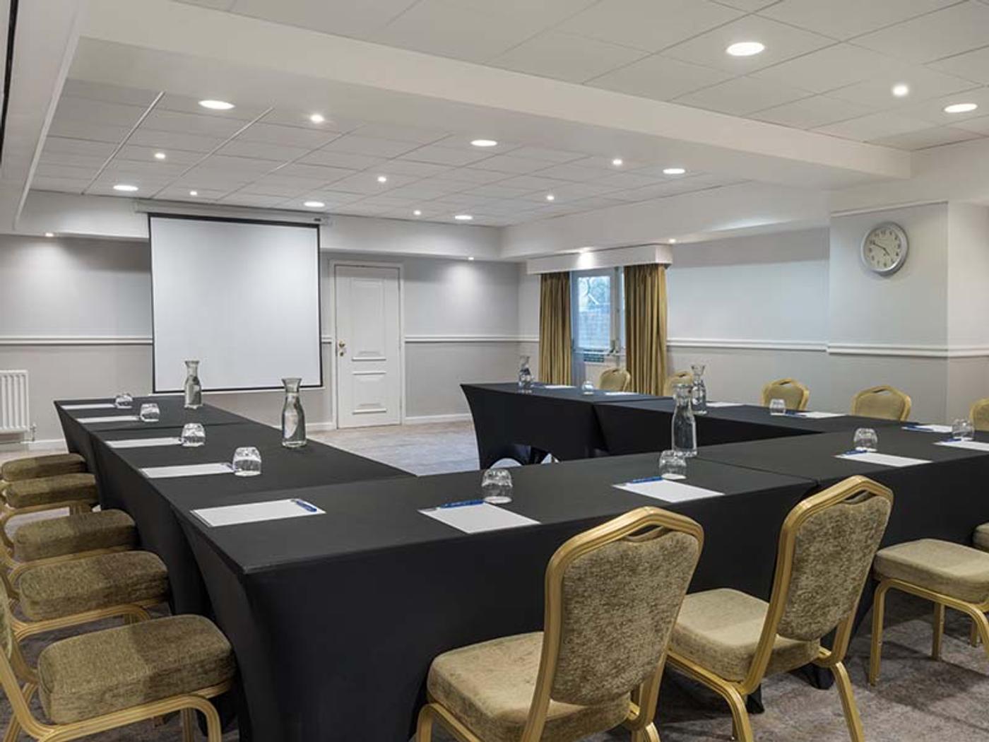 Leeds Room set U-shape with a boardroom table and windows onto greenery