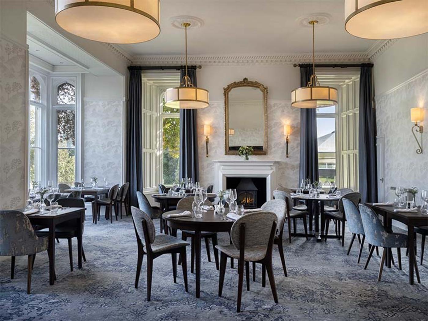 Elegant dining room with fireplace and gilt mirror