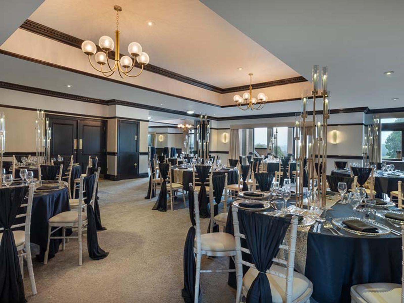 Elegant black-tie dinner reception set with candelabras at Delta Hotels Breadsall Priory Country Club