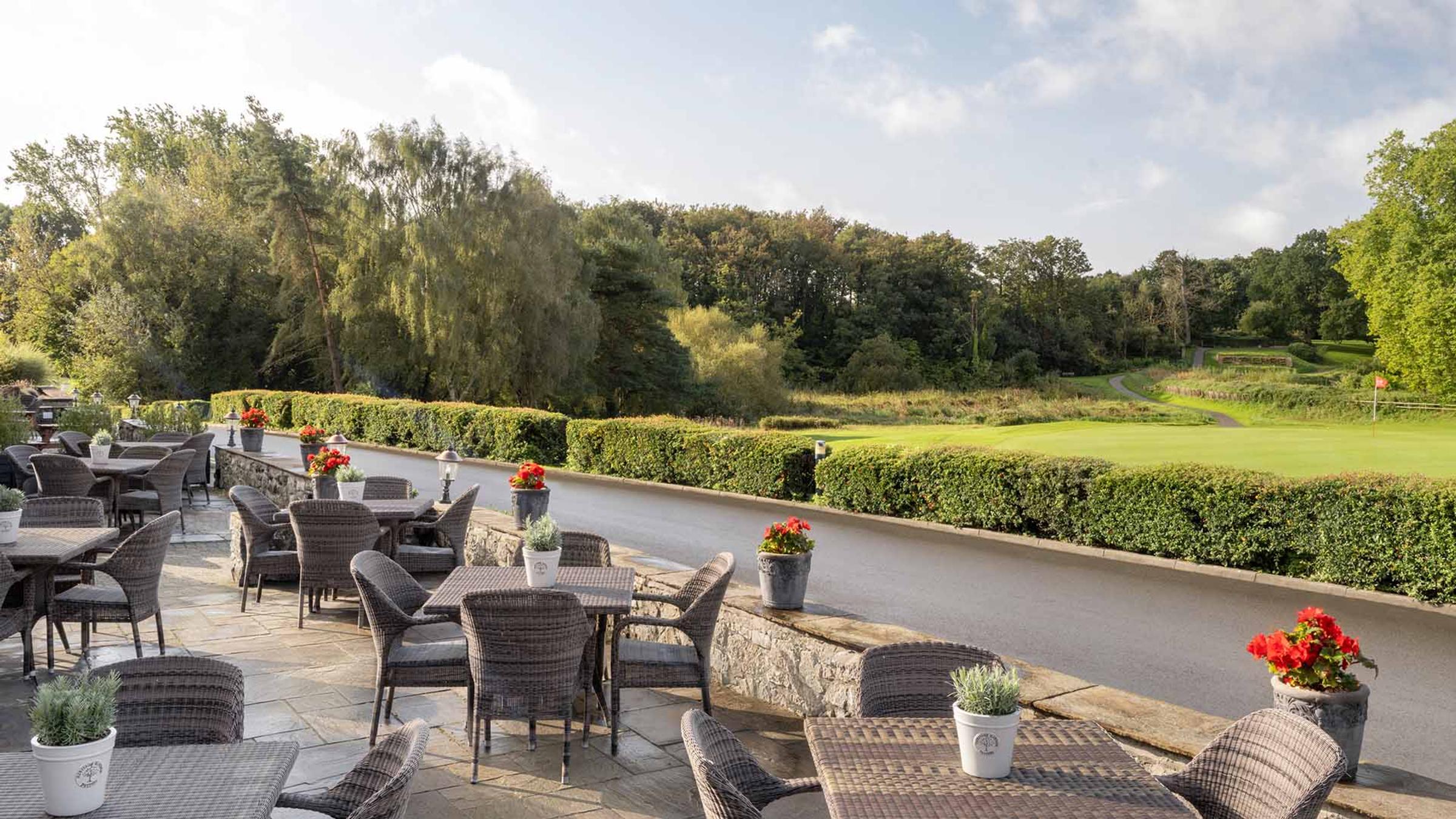 Terrace dining tables set beside the lawn at Delta Hotels St. Pierre Country Club