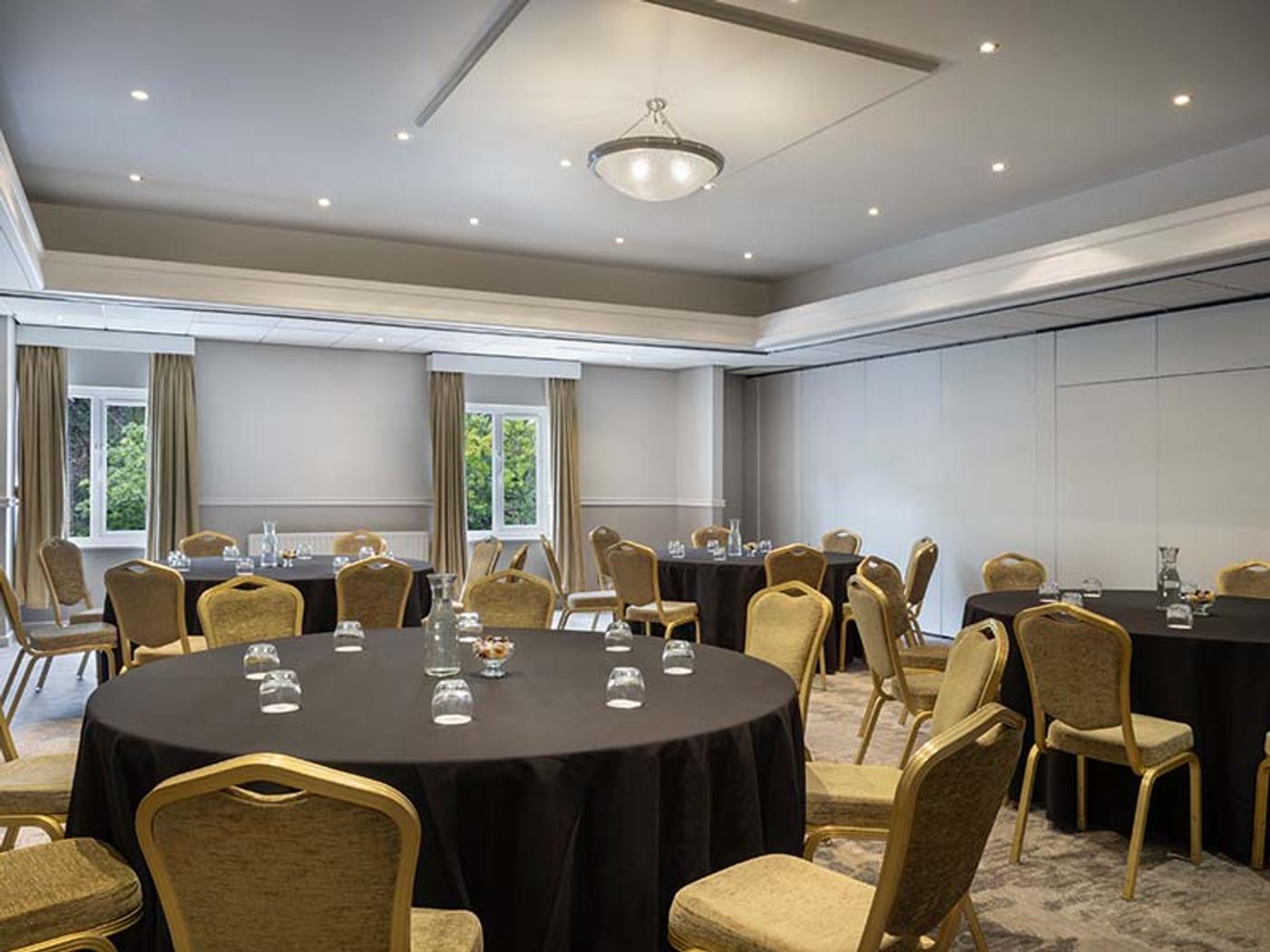 Lenham Room set cabaret-style with round tables and a folding partition wall