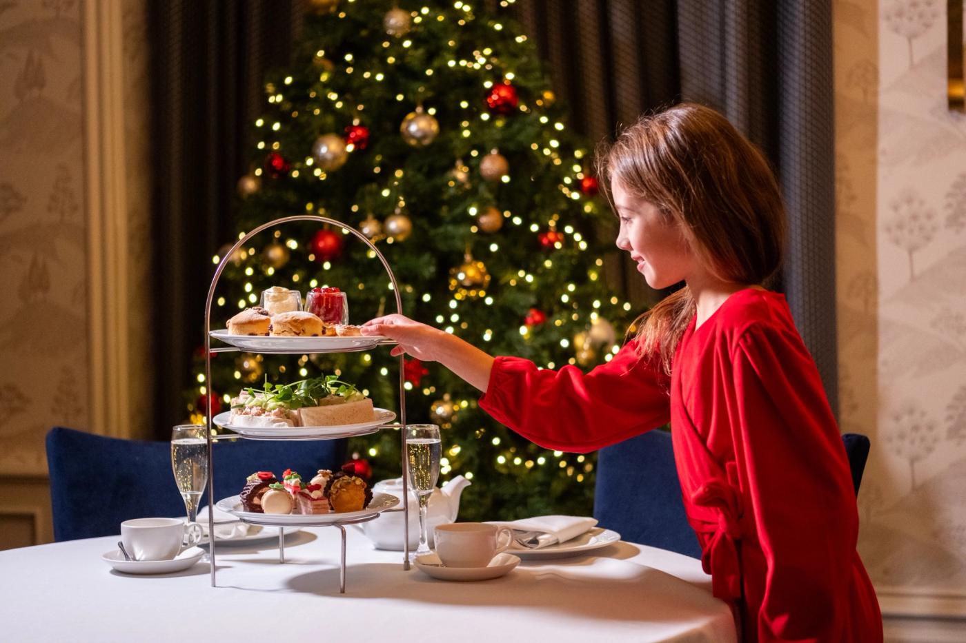 Christmas afternoon tea stand in front of Christmas tree