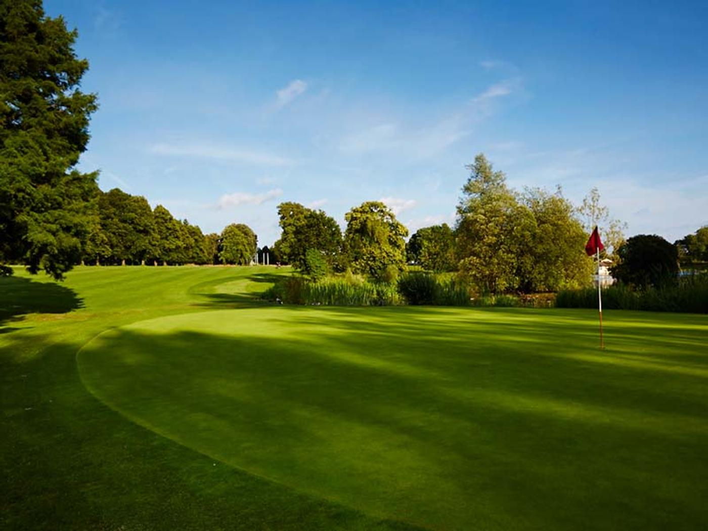 Golf green with flag beside the lake at Delta Hotels St. Pierre Country Club