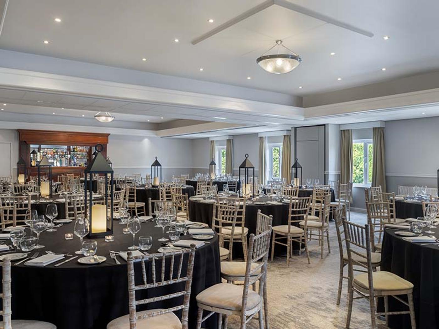 Private dining room set with round tables, candelabra and chiavari chairs