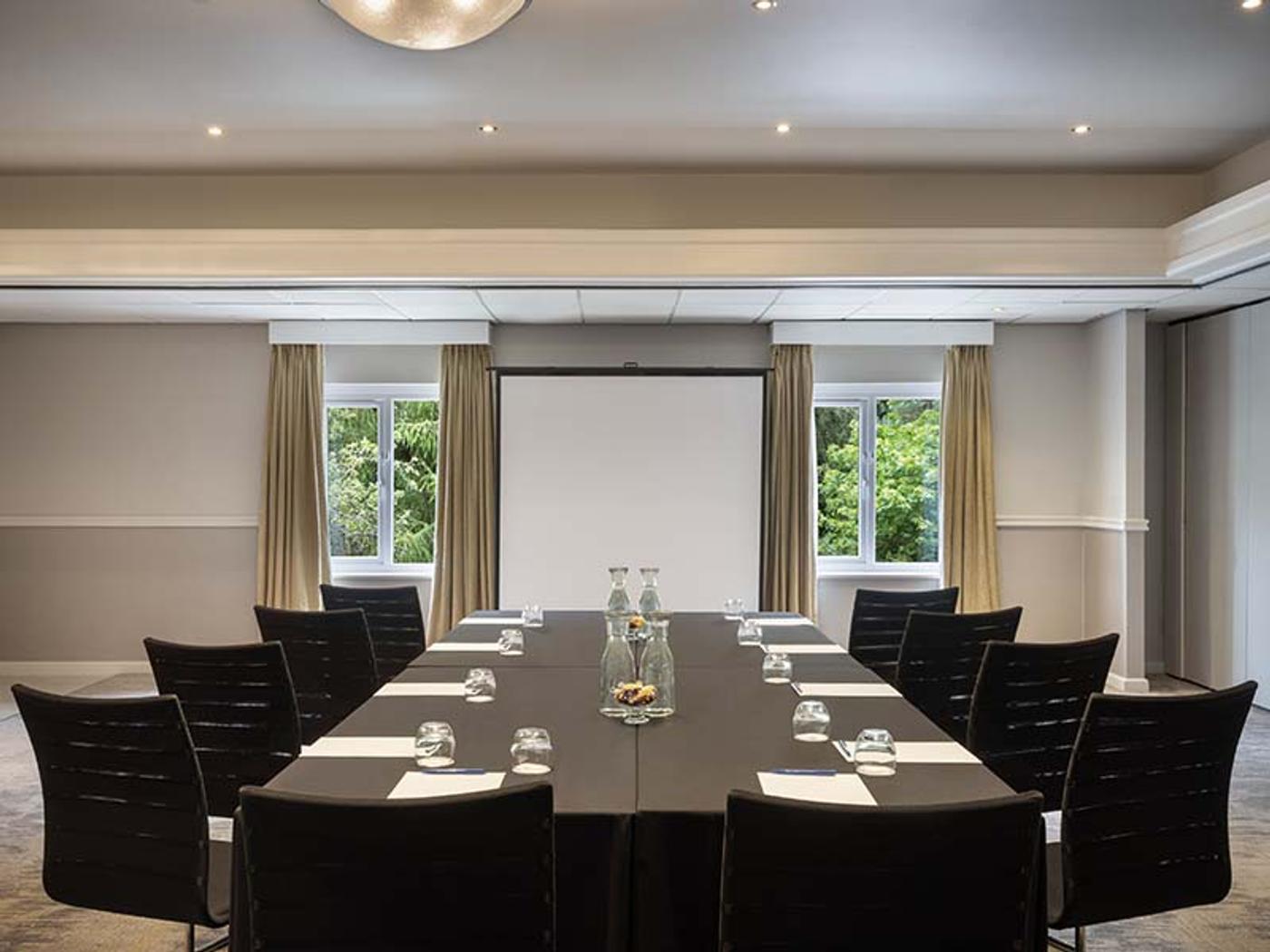 Charlotte Room set boardroom-style with a large screen