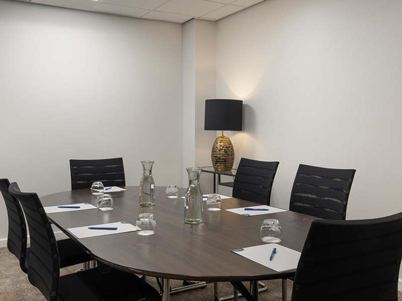 Syndicate room set boardroom-style for a small meeting