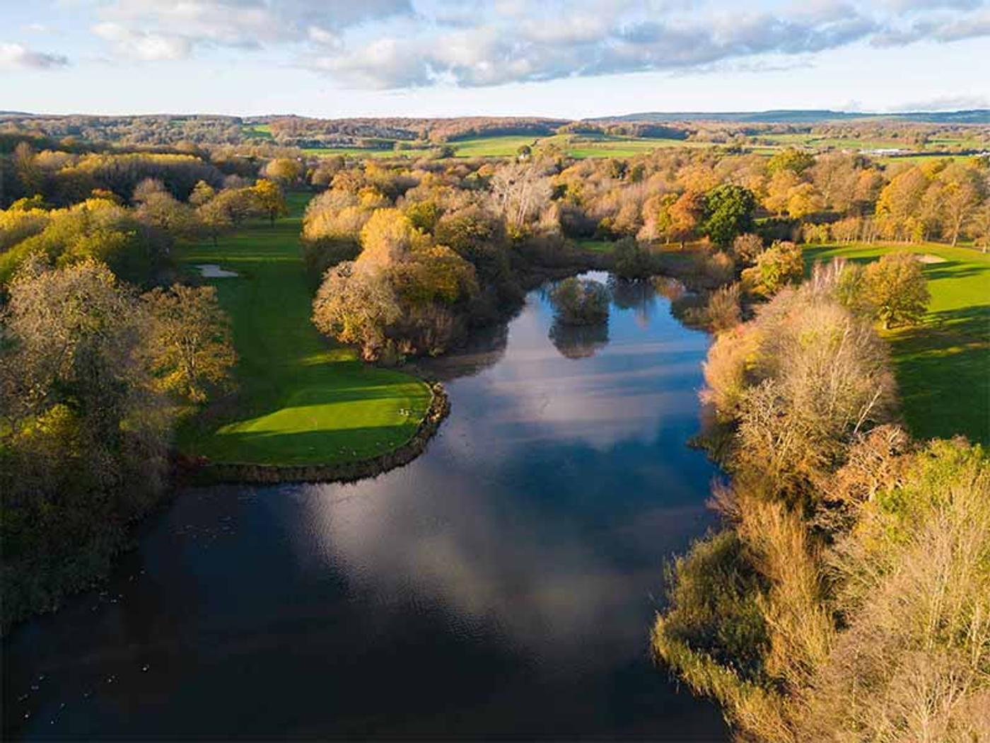 Aerial view of Delta Hotels St. Pierre Country Club's golf course and lake in autumn
