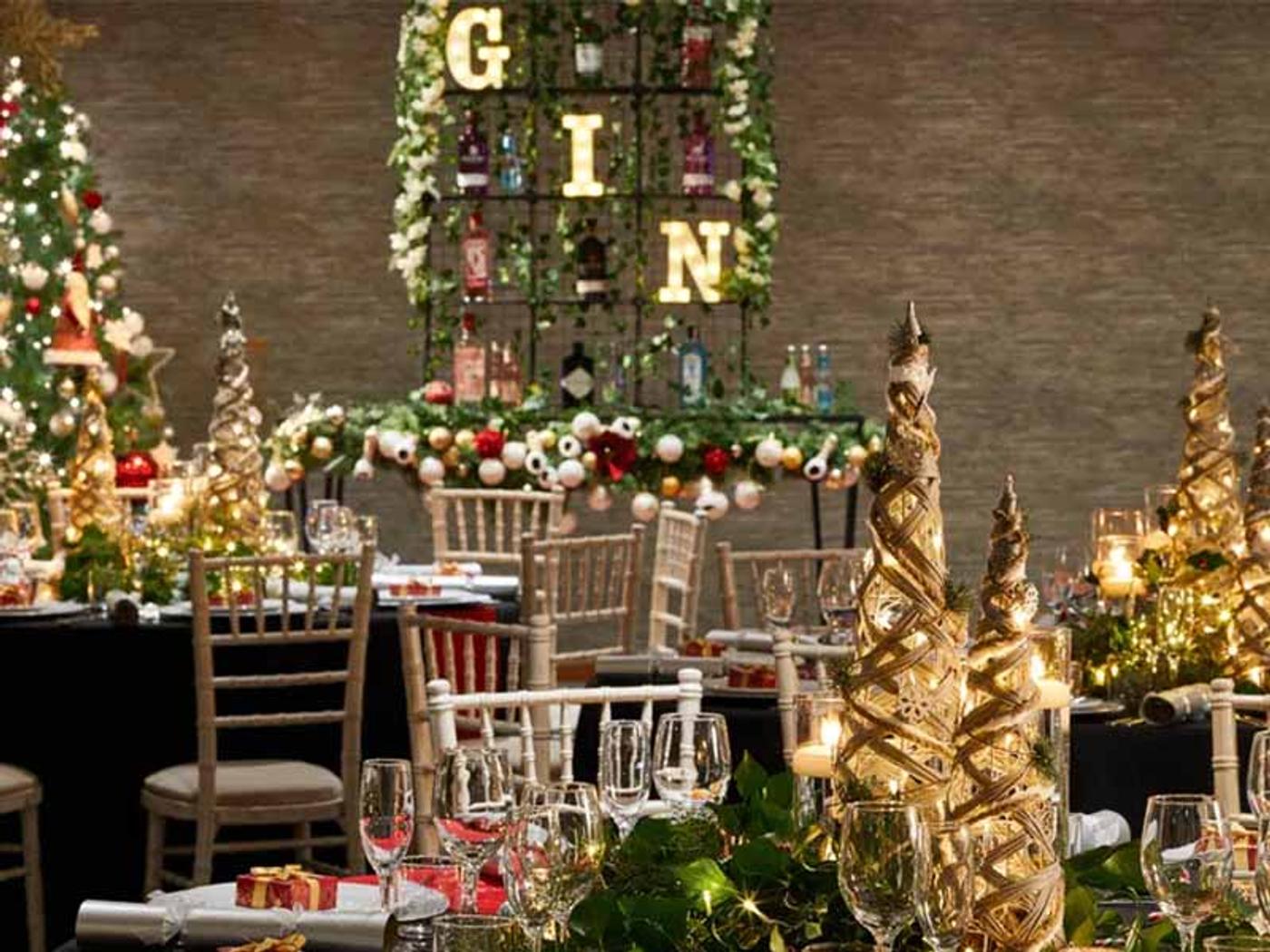 Christmas dinner table set with festive decorations and a lit gin display at Delta Hotels by Marriott Tudor Park Country Club
