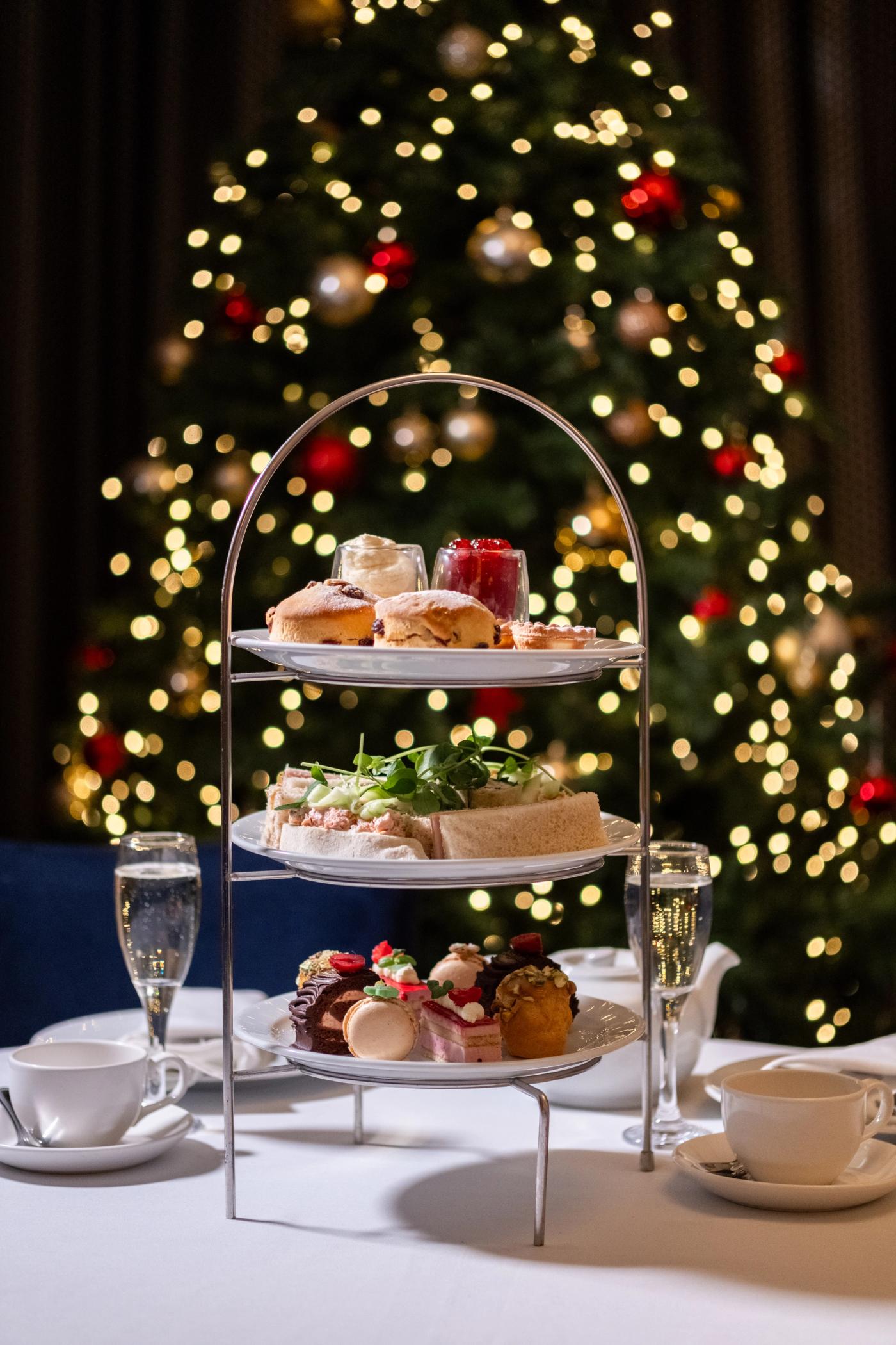 Christmas afternoon tea stand in front of Christmas tree