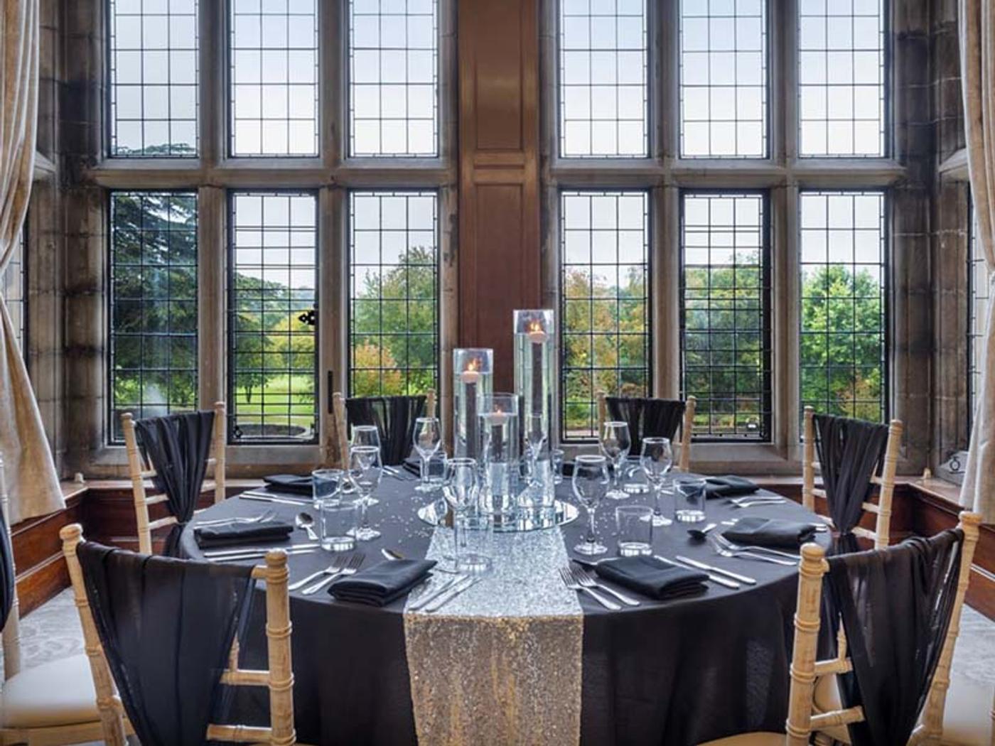 Elegant dining room with a skylight and chandelier at Delta Hotels Breadsall Priory Country Club