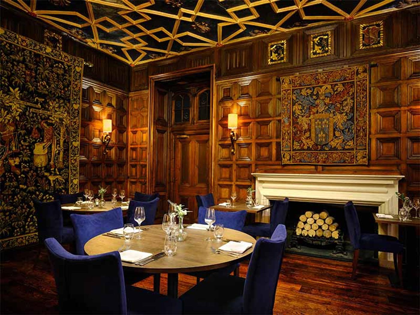 Oak-panelled private dining room with tapestries and a fireplace at Delta Hotels St. Pierre Country Club