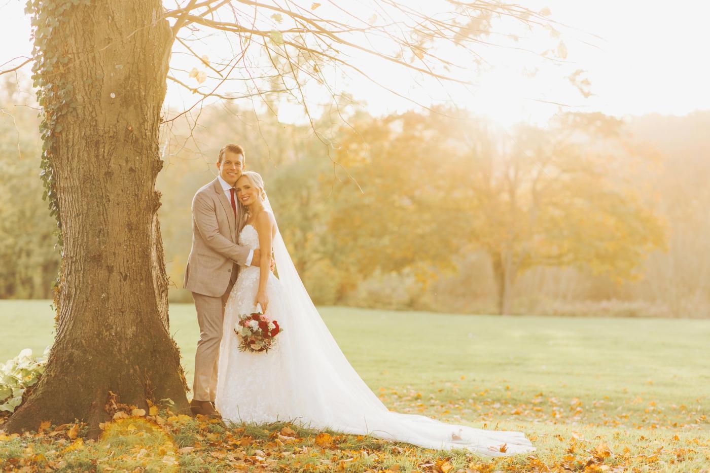 Bride and Groom posing under tree