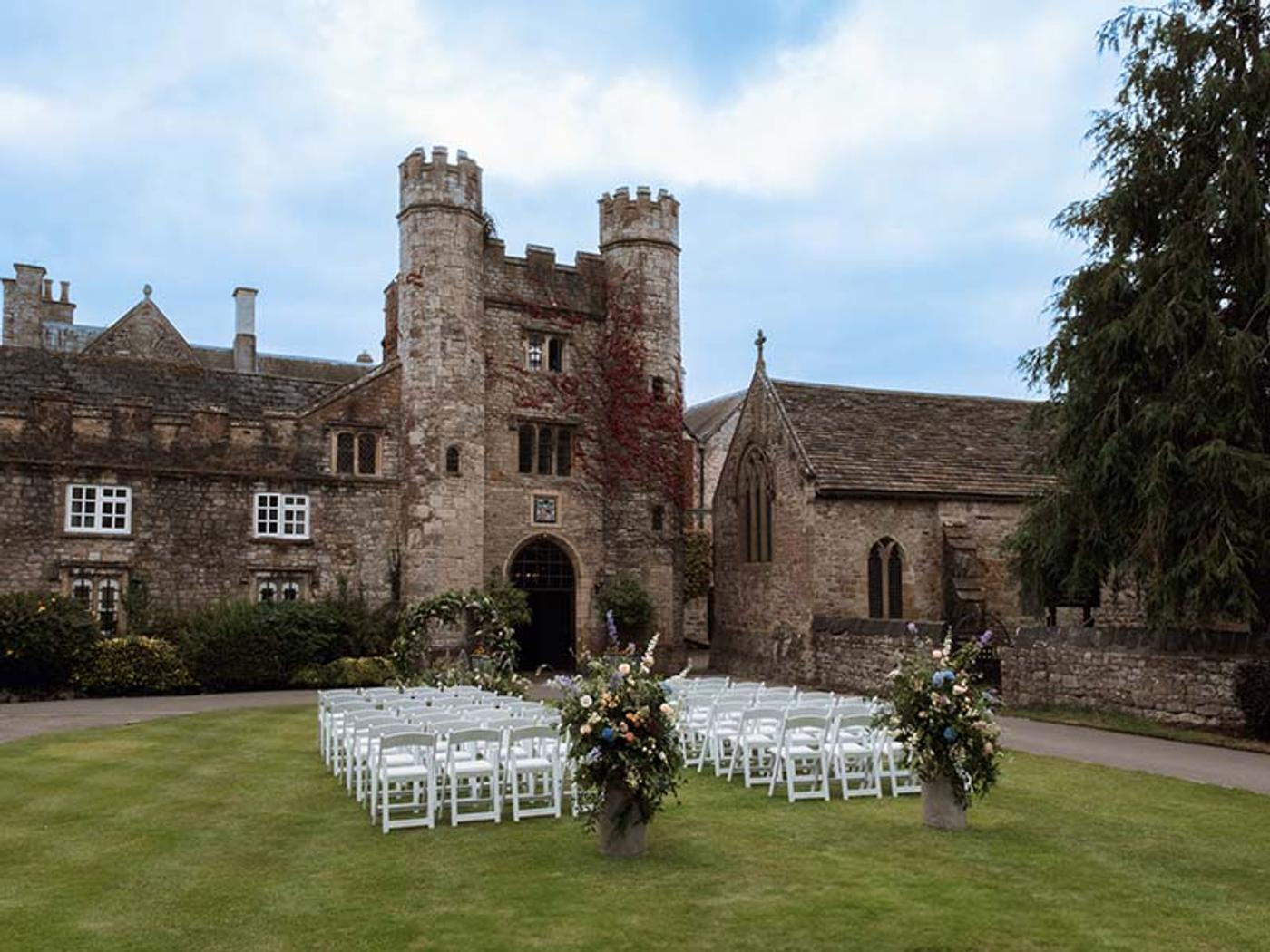 Rows of white chairs set up for an outdoor ceremony on the lawn at Delta Hotels St. Pierre Country Club