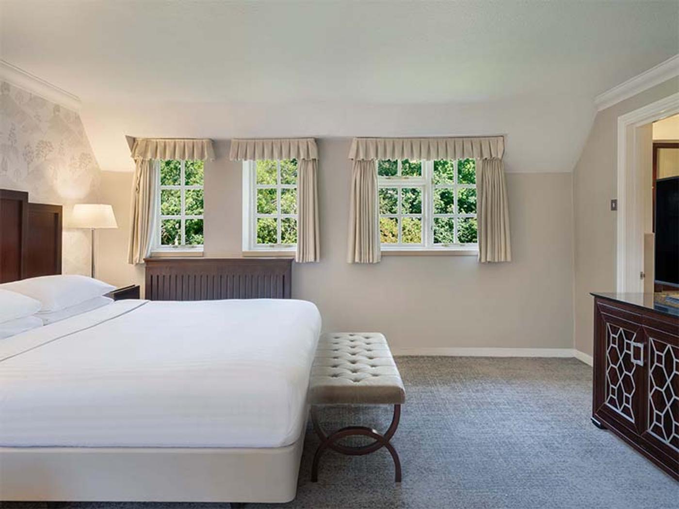 Bedroom seating area with desk and armchairs