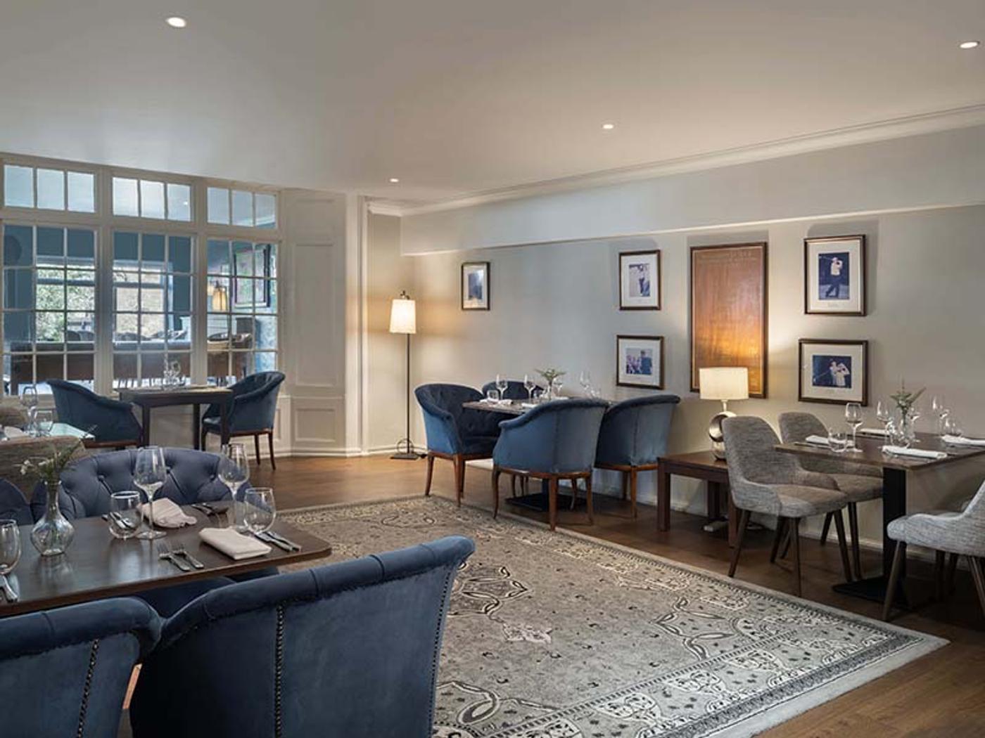 Elegant dining room styled with golf memorabilia and blue chairs