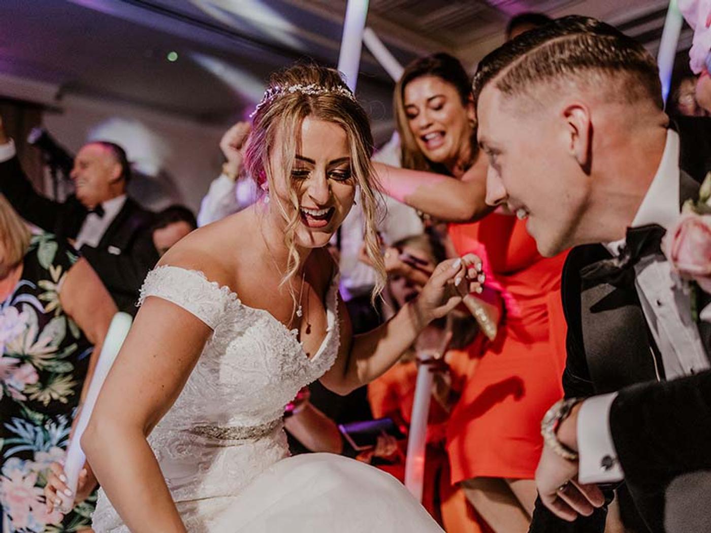 Bride laughing with guests on the dance floor at Delta Hotels by Marriott Tudor Park Country Club