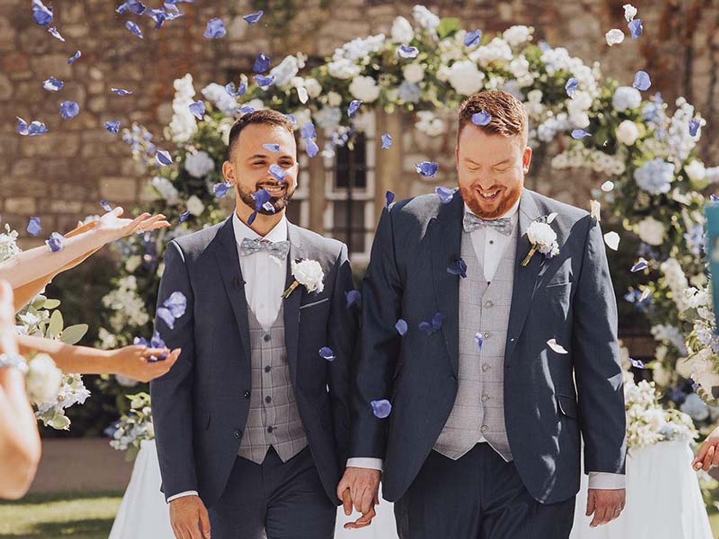 Couple walking through an outdoor confetti toss at Delta Hotels St. Pierre Country Club