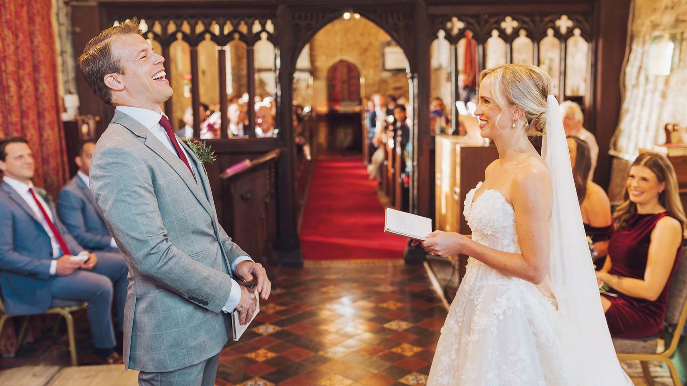 Bride and groom laughing together during their ceremony at Delta Hotels St. Pierre Country Club's on-site church