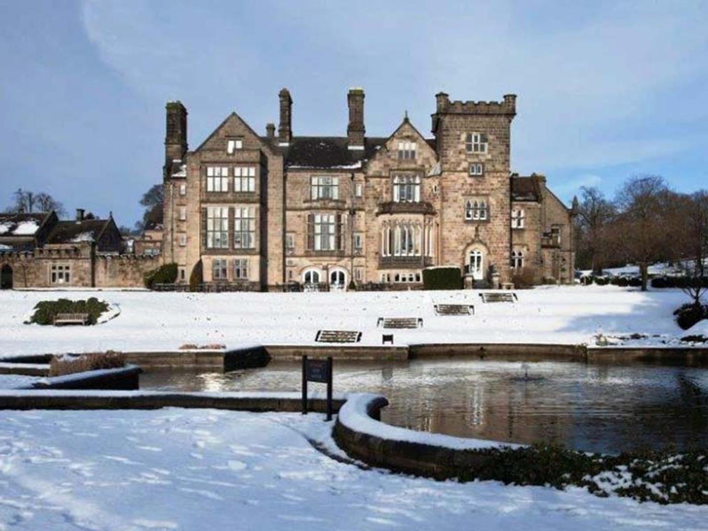Delta Hotels Breadsall Priory Country Club's manor house and lake covered in snow
