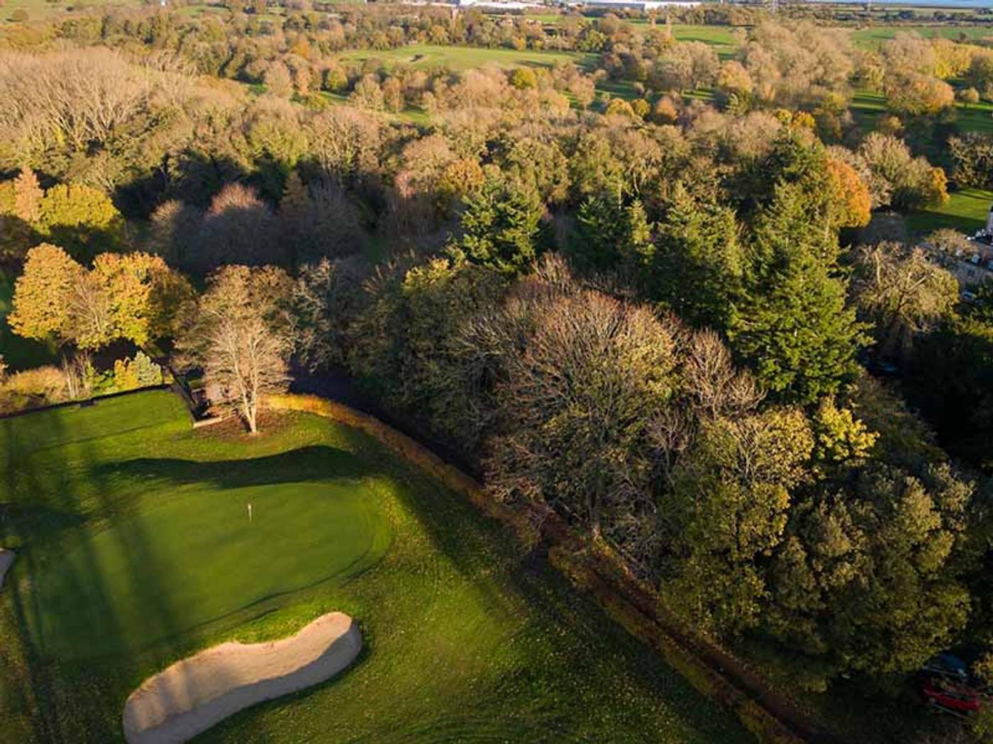 Aerial view of a green and bunker at Delta Hotels St. Pierre Country Club in autumn