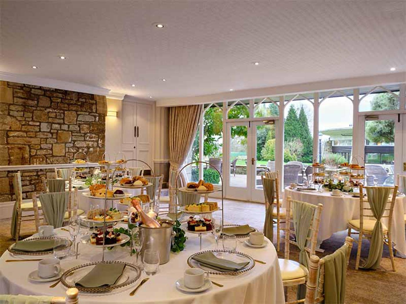 St David's Room set up for afternoon tea with French doors opening onto the terrace