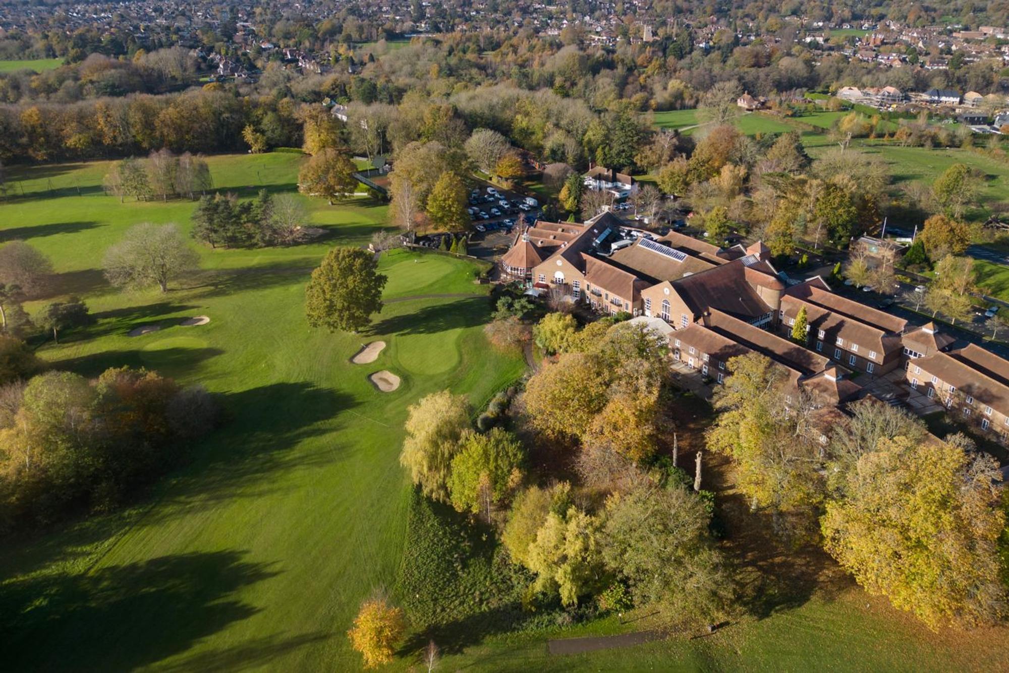 Aerial view of Delta Hotels by Marriott Tudor Park Country Club's golf course and clubhouse in autumn