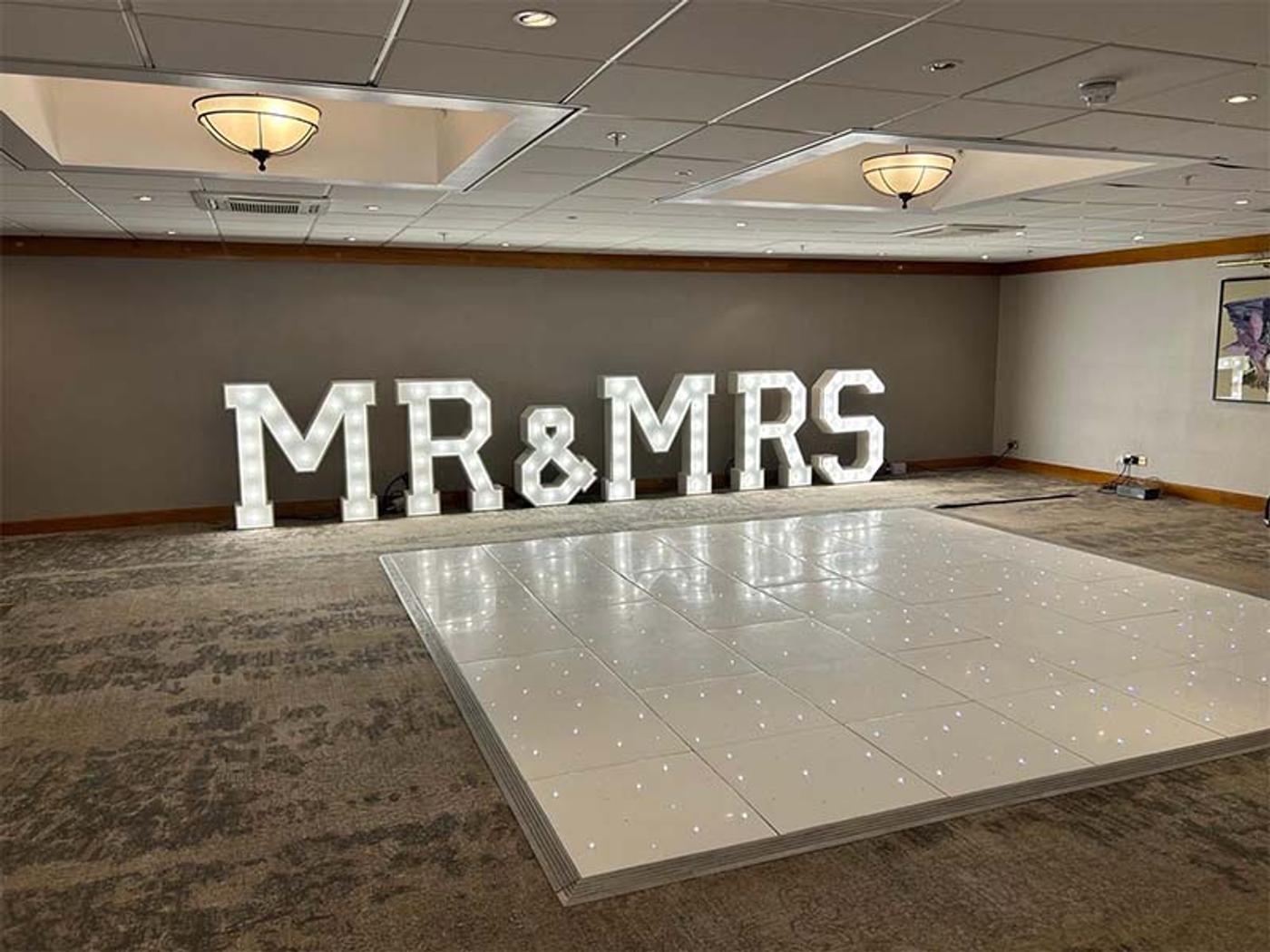 White dance floor with light-up MR & MRS letters in the Bearsted Room