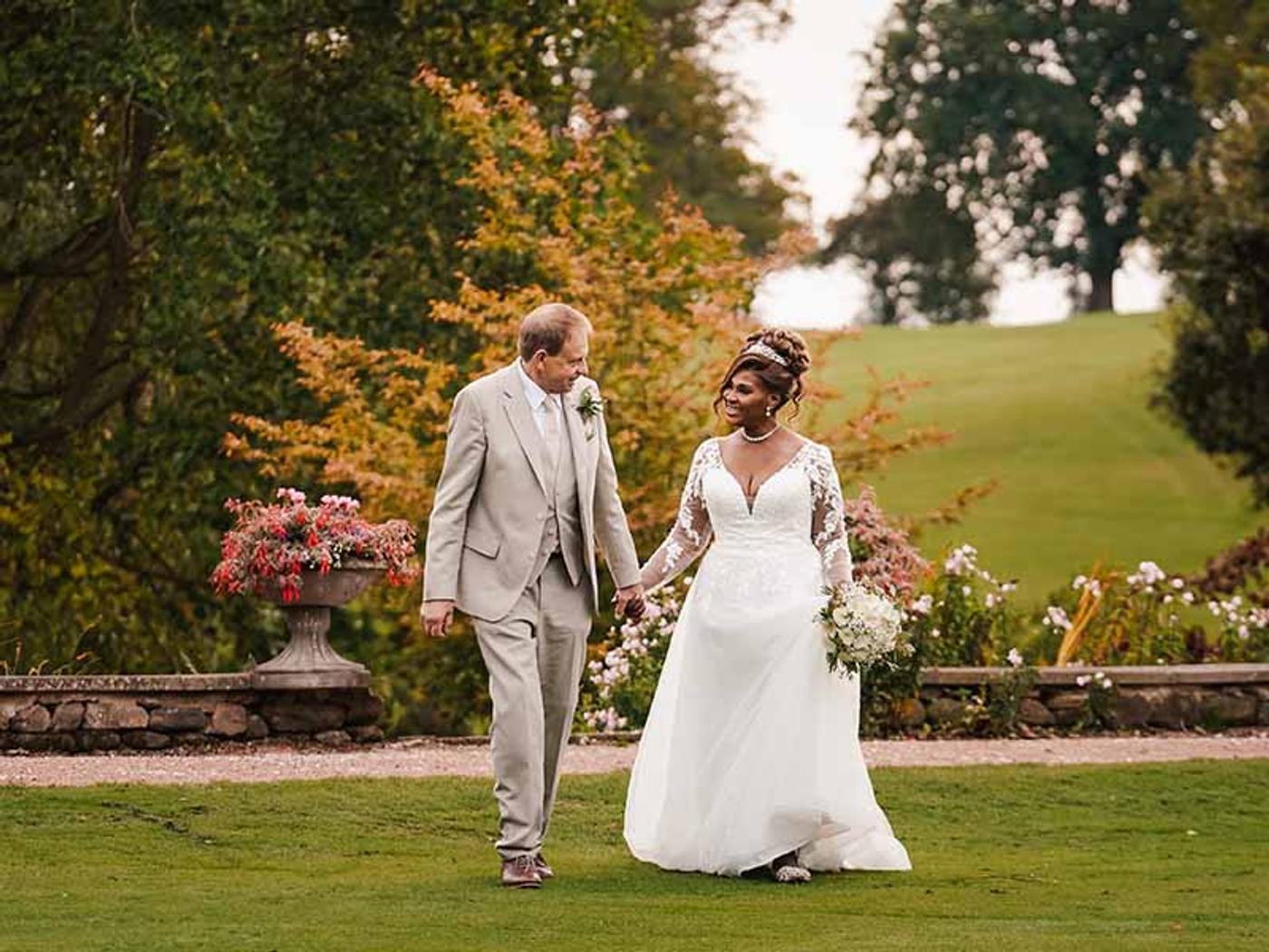 Bride and groom portrait against Delta Hotels Breadsall Priory Country Club's stone facade
